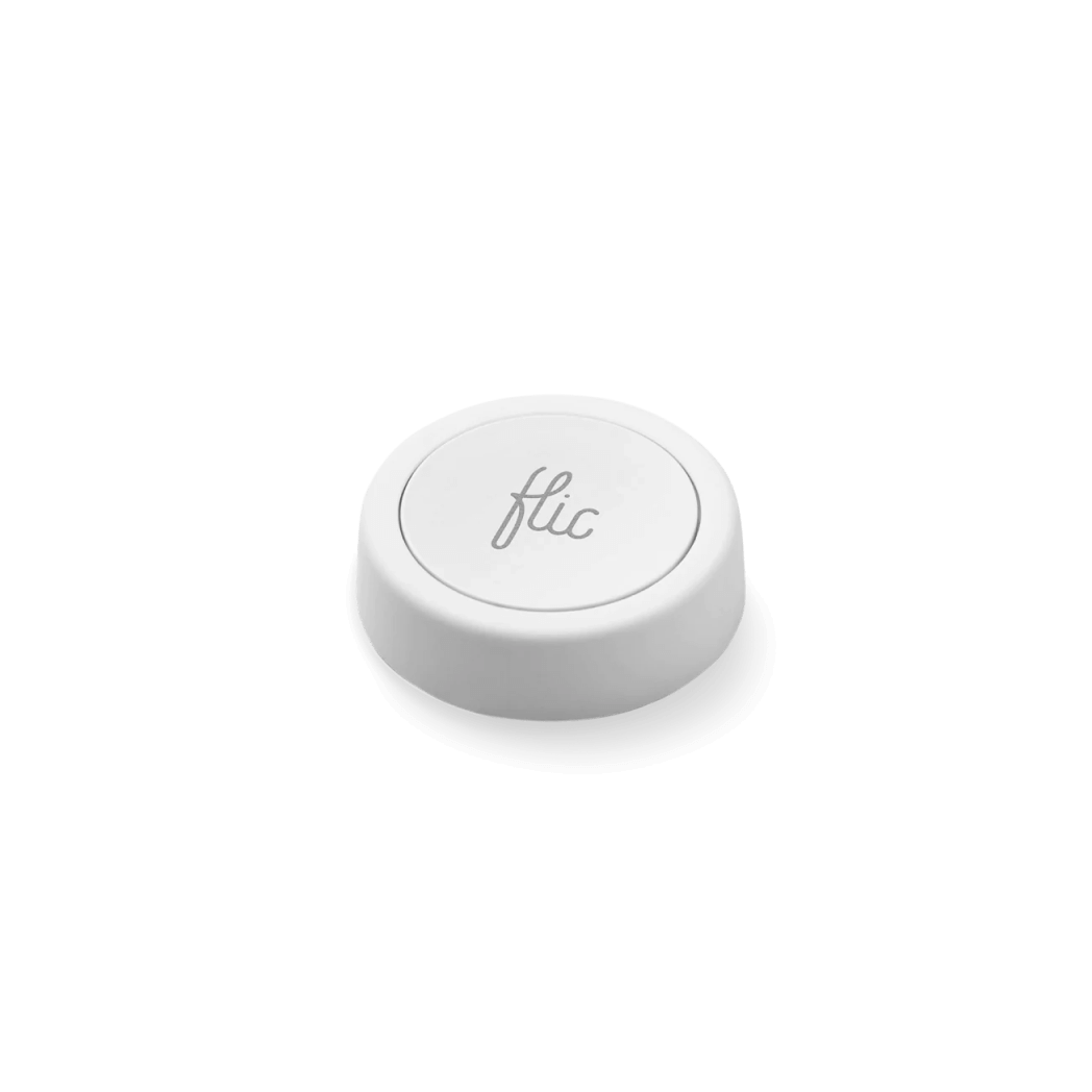 A single white Flic Smart Button on a clean surface.