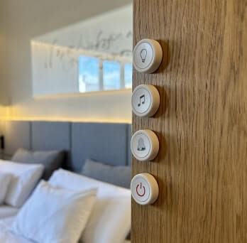 A discreet Flic panic button mounted at a hotel service station.